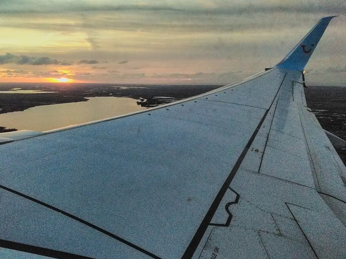 Aircraft wing at sunset Aircraft wing at sunset, representing the airline inventory travel businesses reach through flight APIs